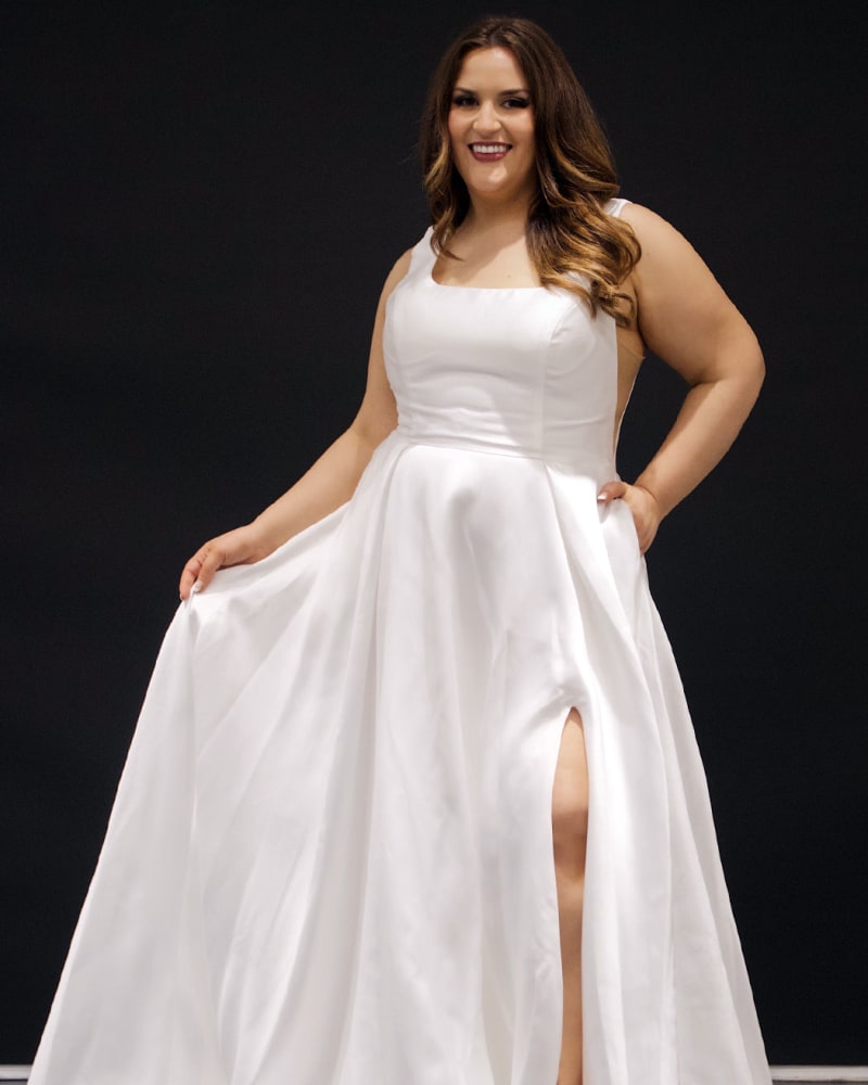 Front of a model wearing a size 20 Avril Wedding Dress in Ivory by Sydney's Closet. | dia_product_style_image_id:285784